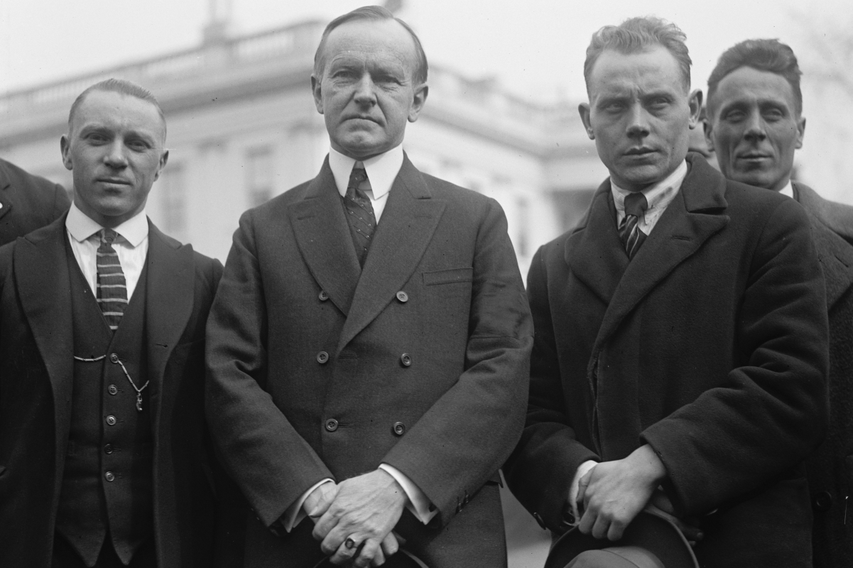 Nurmi, right, and Joie Ray, left, with U.S. President Calvin Coolidge during Nurmi's 1925 U.S. tour.