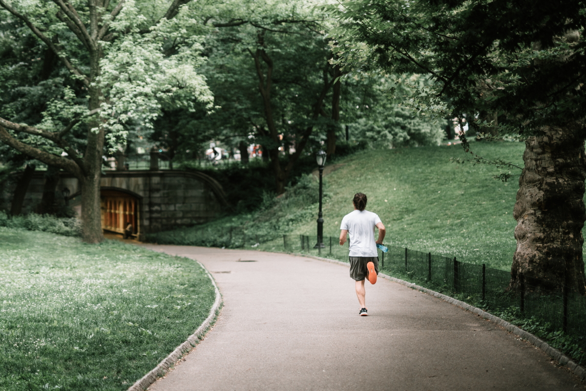 A man is running in the park.